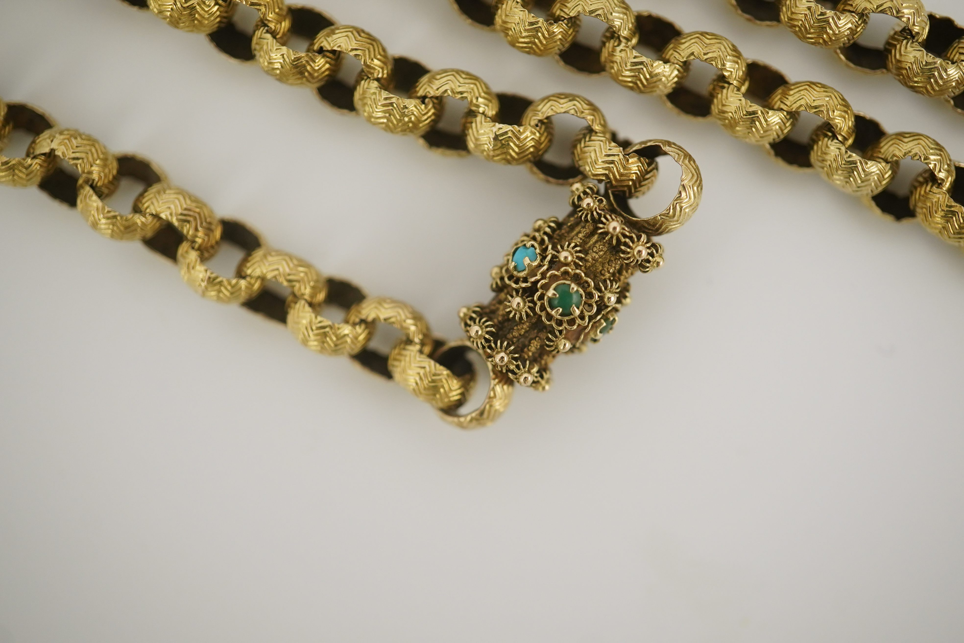 A Georgian gold textured circular link muff chain, with turquoise cluster set barrel shaped clasp